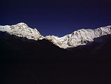 307 Annapurna South, Fang, Annapurna Main, Central, East Summits After Sunrise From Annapurna Sanctuary Base Camp �Our little valley pointed straight up to the Face which towered above us about three miles away. It formed a magnificent centrepiece to what must be one of the most impressive mountain cirques in the world; the ridge linking Modi Peak [Annapurna South] with our mountain was like a turreted wall linking two fortresses and never dropped below 21,000 feet� (Chris Bonington, Annapurna South Face).